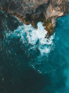 A blue ocean hitting cliffs